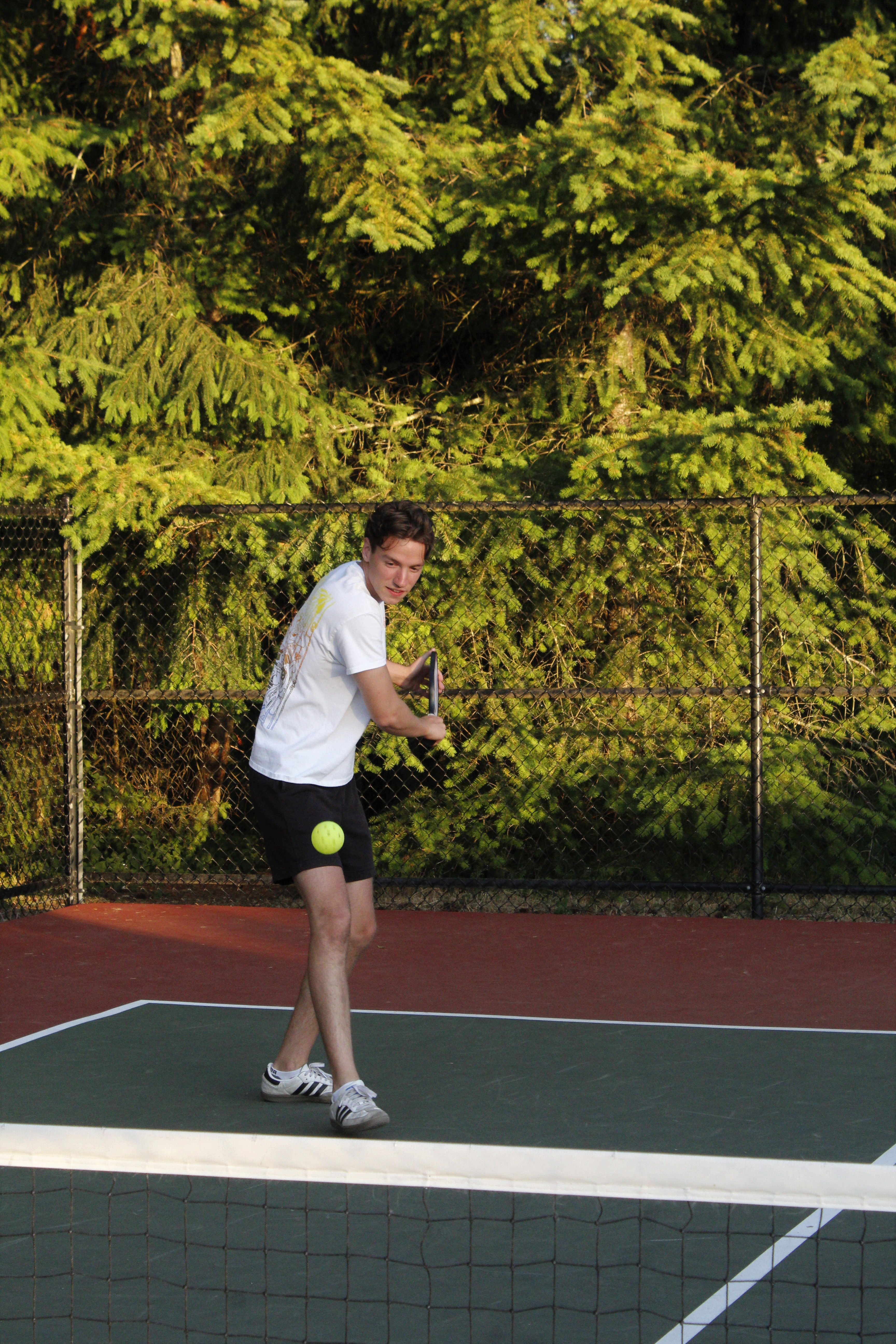 Adult pickleball player hitting a shot