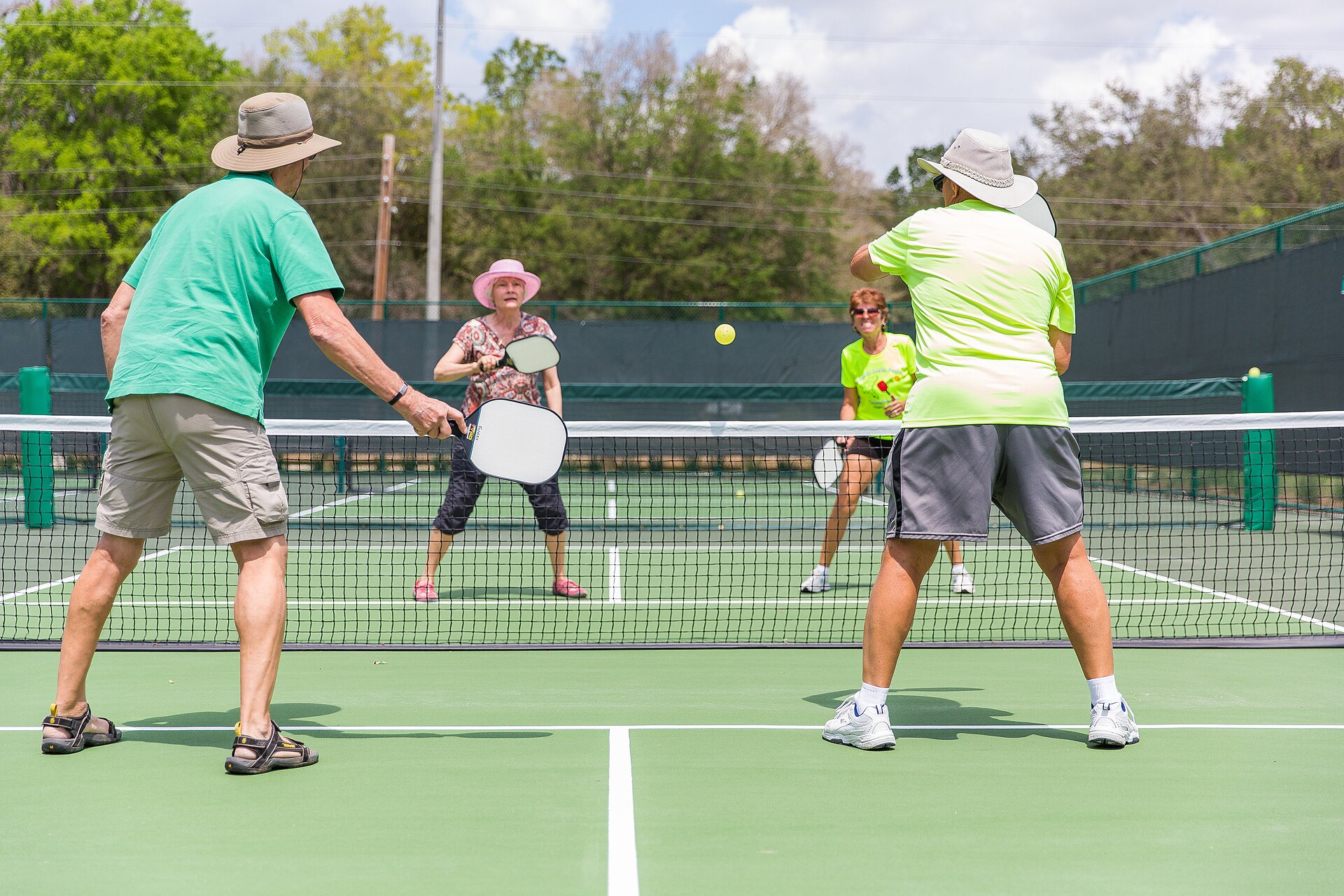 Group of adults playing pickleball doubles
